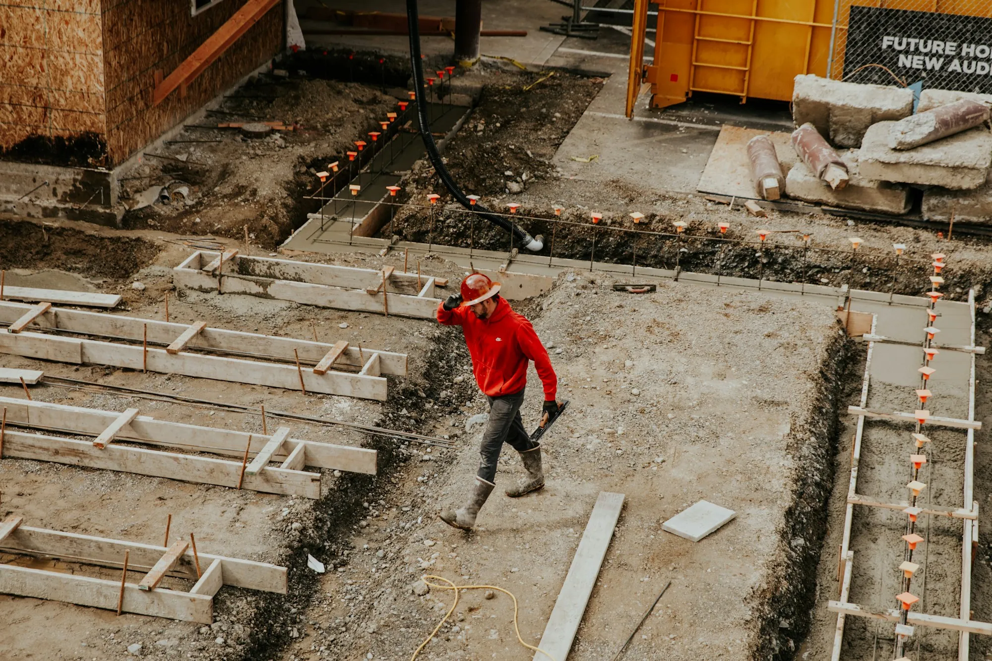 Worker in a footing trench with wood forms