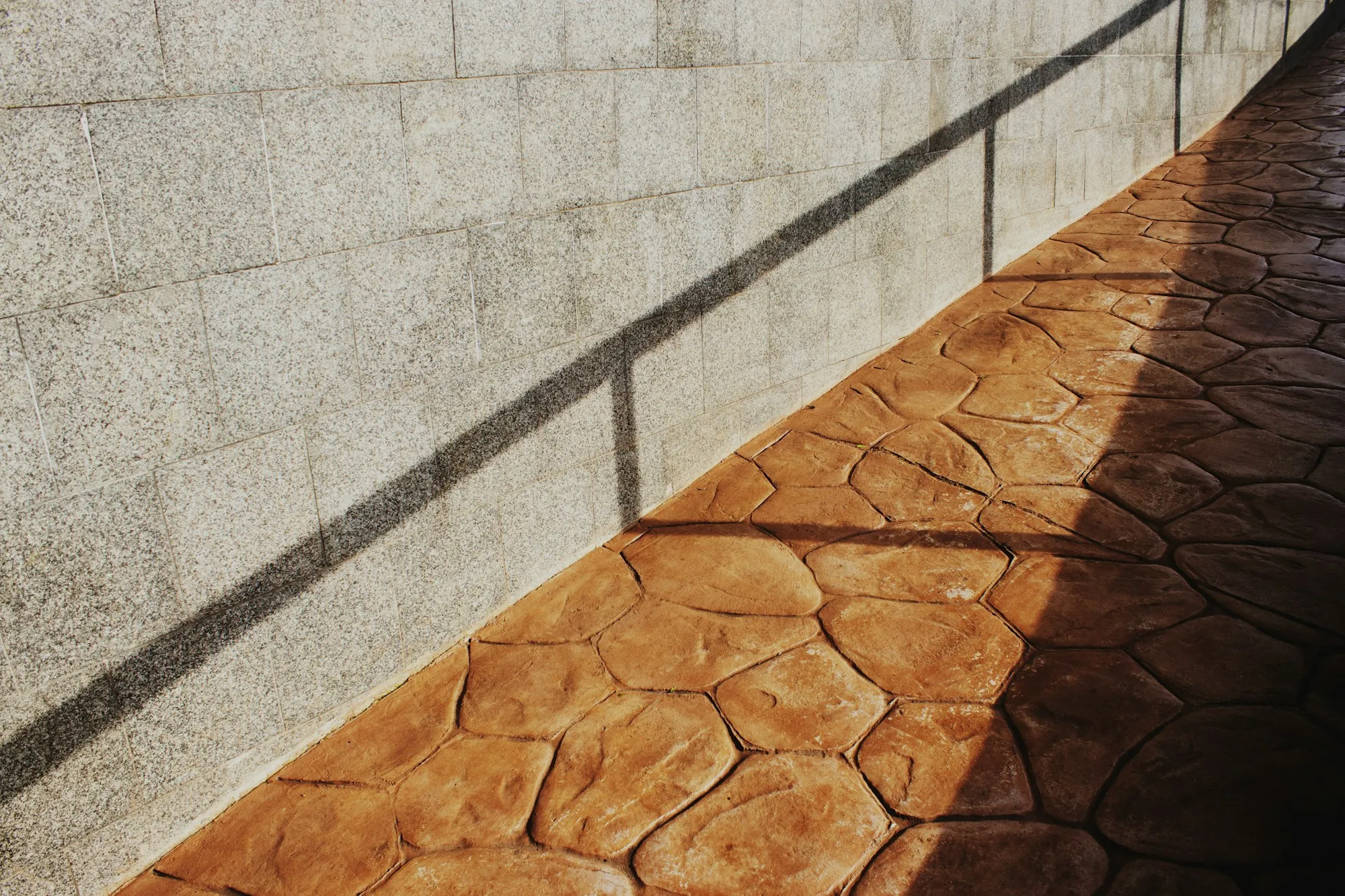 Terracotta-colored stamped concrete with a flagstone pattern